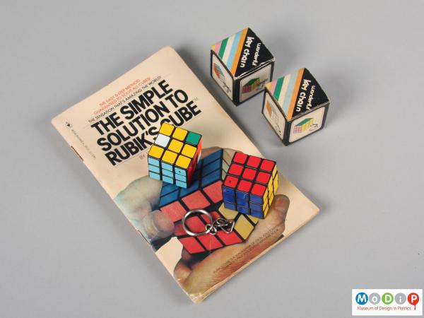 Top view of a puzzle key chain showing both puzzles, the boxes and the book.