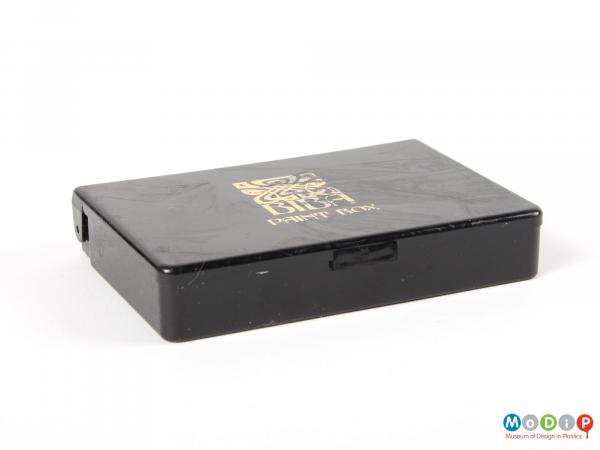 Side view of a cosmetics box showing the straight sides and gold logo.
