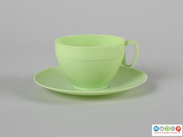 Side view of a cup and saucer showing the cup sitting on the saucer.