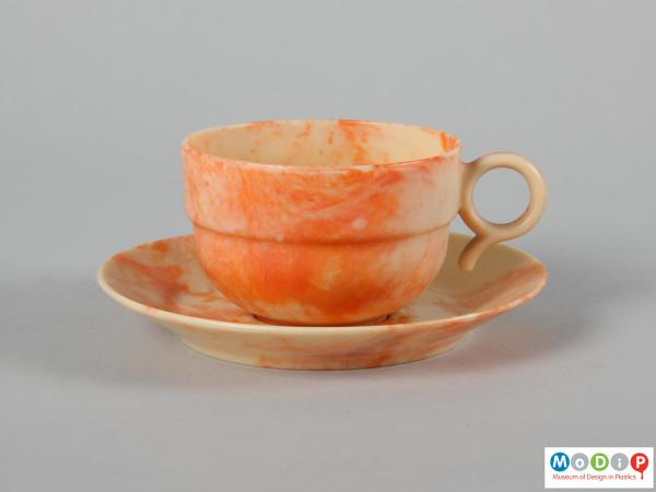 Side view of a cup and saucer showing the circular handle.