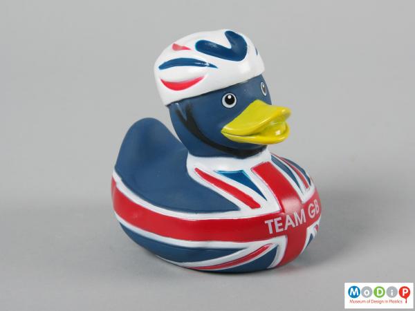 Side view of a duck showing the cycle helmet.