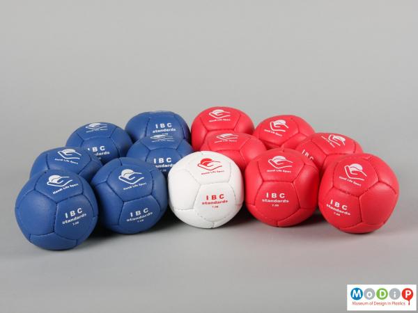 Side view of a set of Boccia balls showing the three colours.