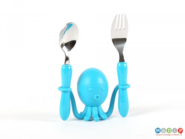 Front view of an egg cup showing the cup holding the spoon and fork.