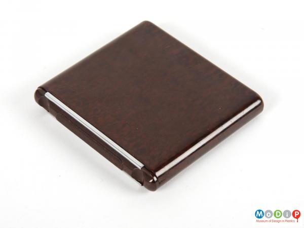 Side view of a cigarette case showing the smooth outer surface.