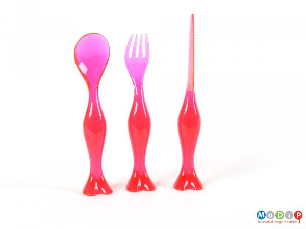 Front view of a set of cutlery showing pieces standing upright.