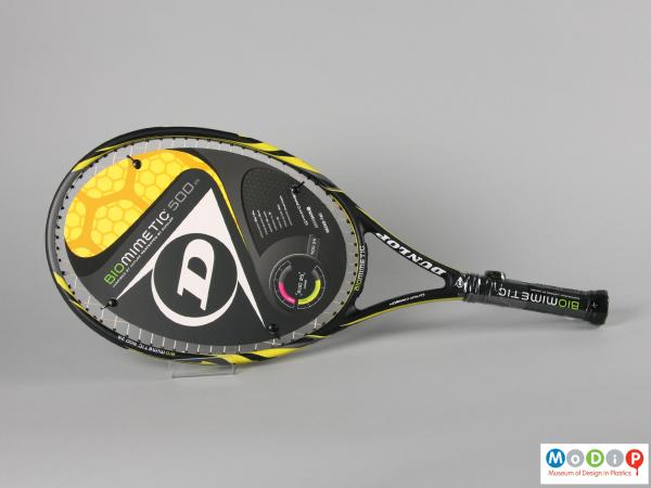Side view of a tennis racket showing the sales card on the head.
