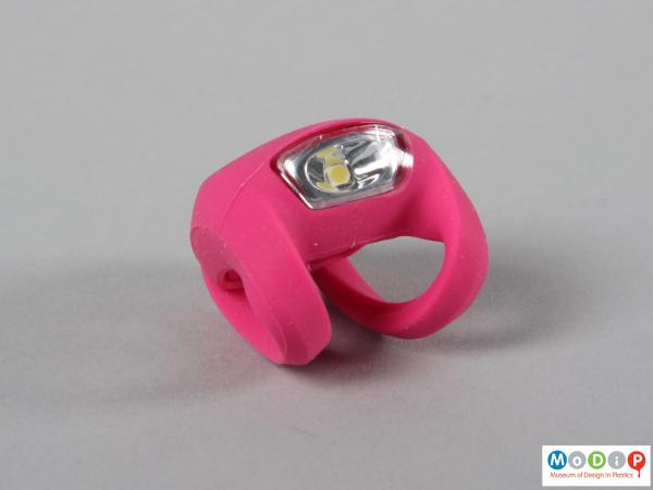 Front view of a bike light showing the white lens and pink body.
