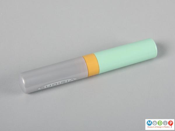 Side view of a tampon case showing the cylindrical shape.