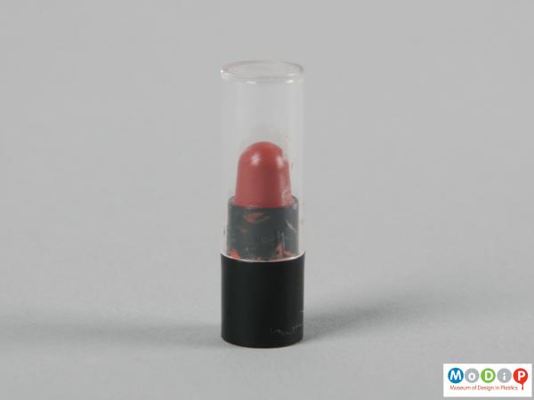 Side view of a lipstick case showing the clear lid and black base.