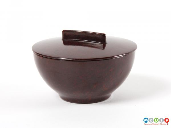 Side view of a lidded pot showing the smooth surface.
