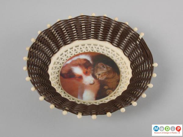 Top view of a basket showing the printed image of a puppy and kitten.