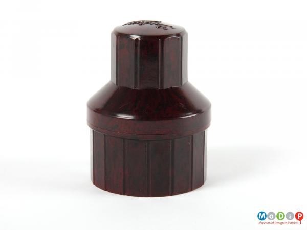 Side view of an ink bottle holder showing the many straight sides.
