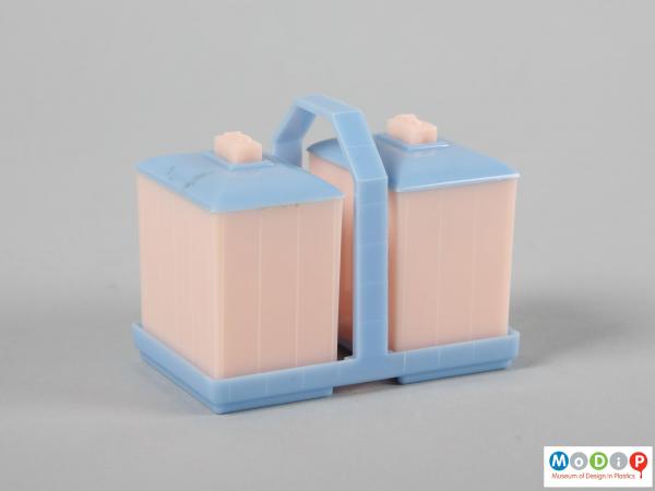 Side view of a cruet set and stand showing the rectangular bodies.
