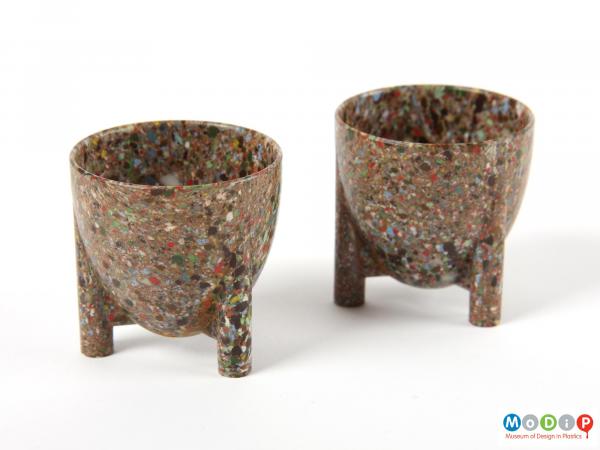 Side view of a pair of egg cups showing the long legs.
