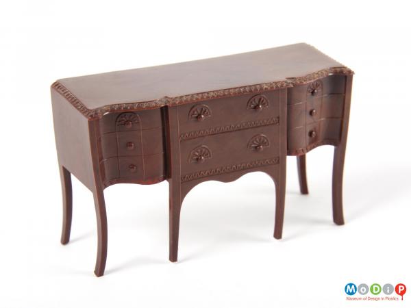 Front view of a toy sideboard showing the moulded detail.