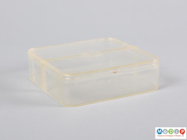 Side view of a food container showing the rounded corners and straight sides.