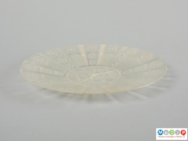 Side view of a plate showing the cut glass style design.