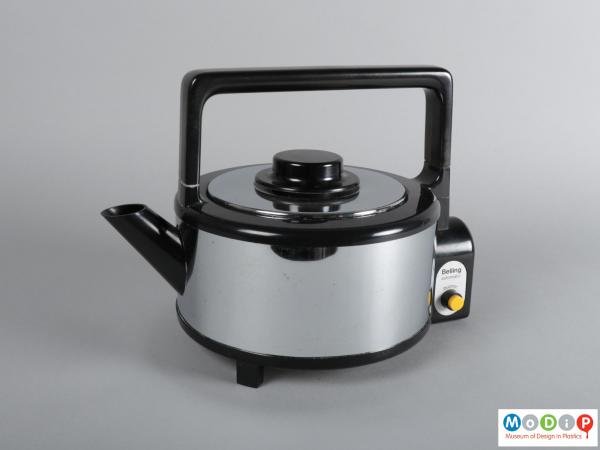 Side view of a kettle showing the square handle and round spout.