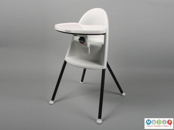 Front view of a highchair showing the table in the widest position.