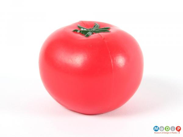 Side view of a toy tomato showing the moulding seam.