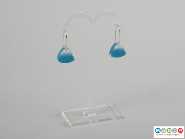 Front view of a pair of earrings showing the blue decoration.