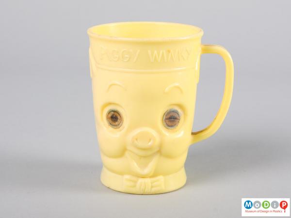 Front view of a beaker showing the moulded pig face.
