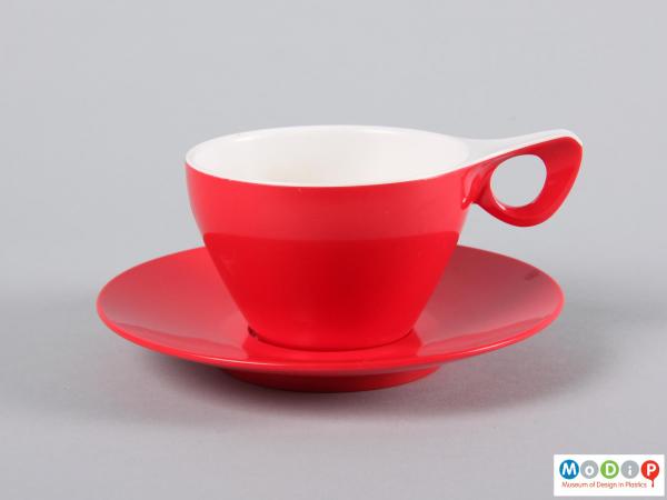 Side view of a cup and saucer showing the elegant handle.