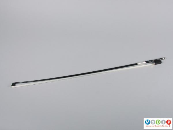 Side view of a violin bow showing the full length.