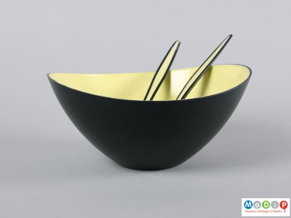 Side view of a salad bowl and servers showing the black and yellow colouring.