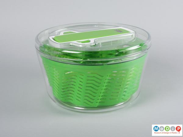 Side view of a salad spinner showing the lid, bowl and basket together.