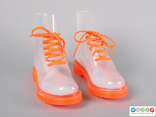 Front  view of a pair of boots showing the orange laces.