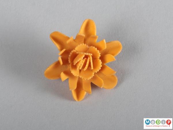 Top view of a brooch showing the curved petals.