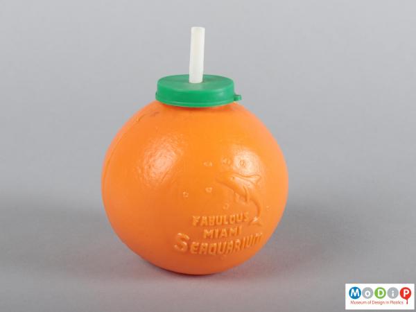 Side view of an orange drink container showing the moulded inscription.