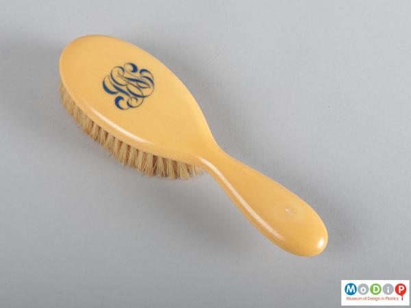 Top view of a hairbrush showing the monogrammed back.