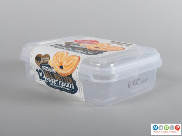 Side view of a pastry container showing the adhesive label over the lid.