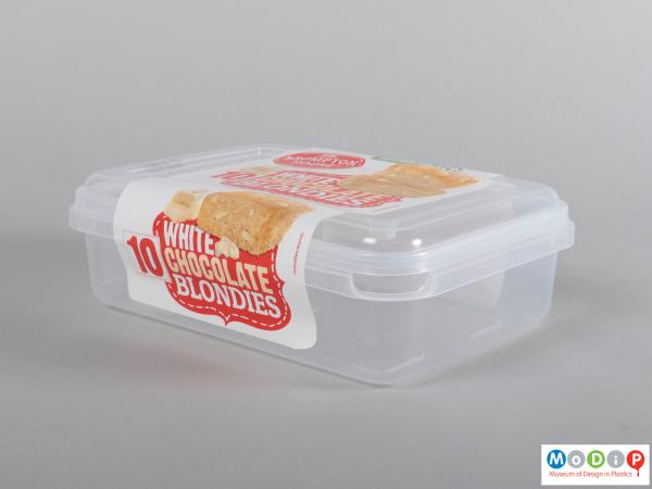 Side view of a cake container showing the adhesive label over the lid.