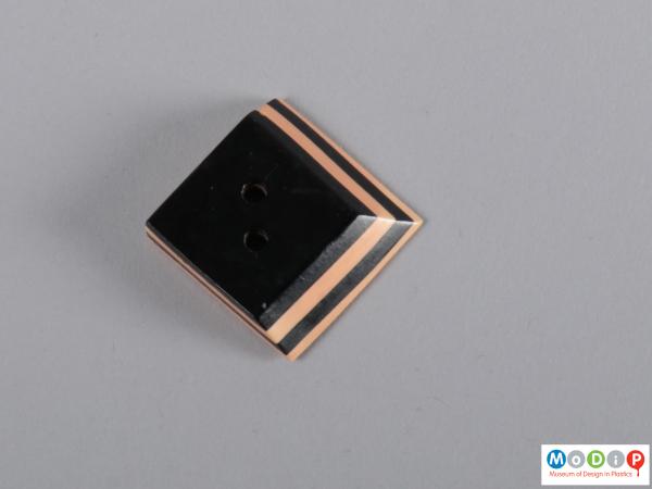 Front view of a button showing the skewed square shape.