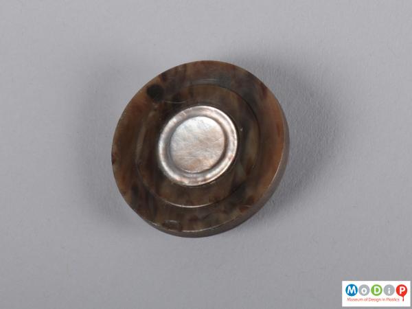 Front view of a button showing the circular shape.