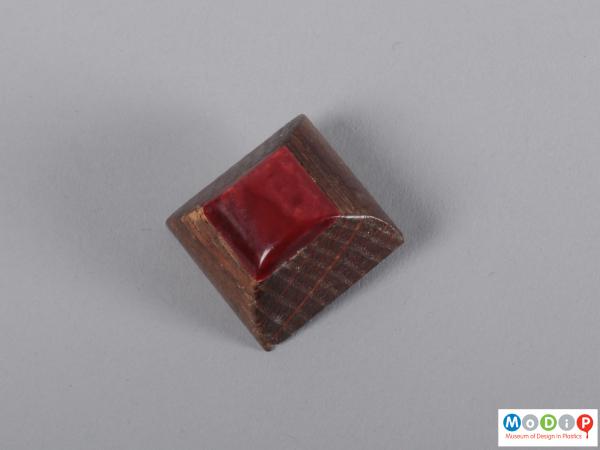 Front view of a button showing the square shape.