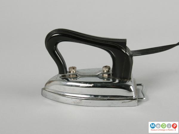 Side view of an iron showing the curved handle.
