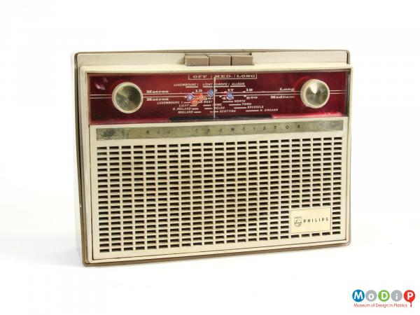 Front view of a Philips L3G03T transistor radio showing two round dials and a rectangular grill on the front along with three buttons at the top.