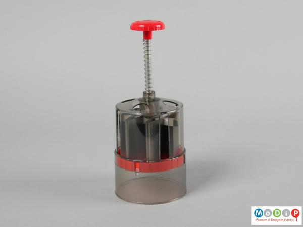 Side view of a food chopper showing the spring loaded handle.