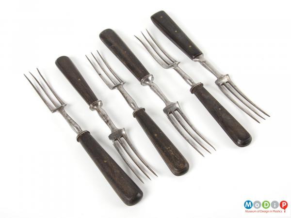 Top view of a horn cutlery set showing the top side of all the forks.