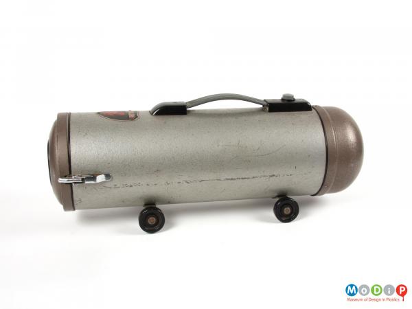 Side view of a vacuum cleaner showing the cylindrical shape.