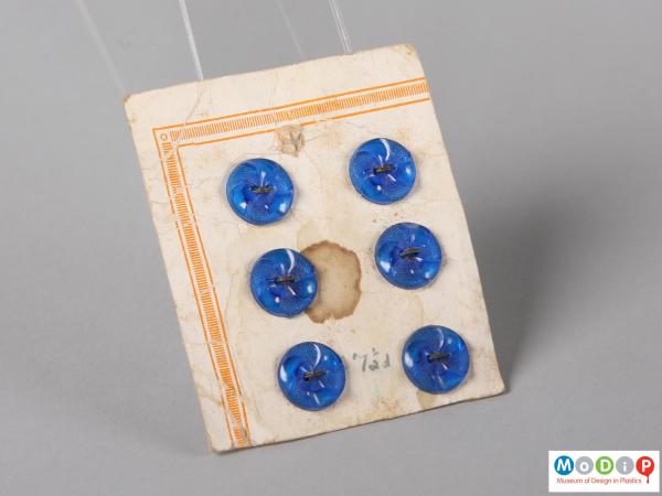 Front view of a sales card of royal blue buttons showing three rows of two buttons.