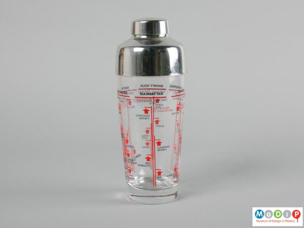 Side view of a cocktail shaker showing the printed information running around the surface.