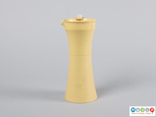 Side view of an oil or vinegar container showing the spout.