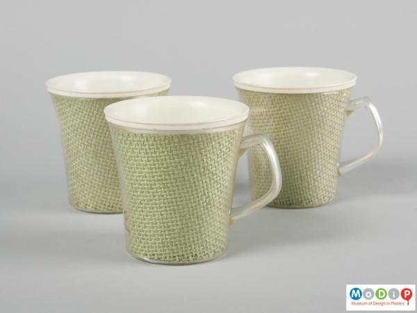 Side view of a group of 3 mugs showing the handles.