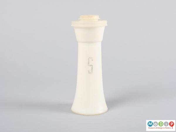Side view of a salt shaker showing the printed letter.