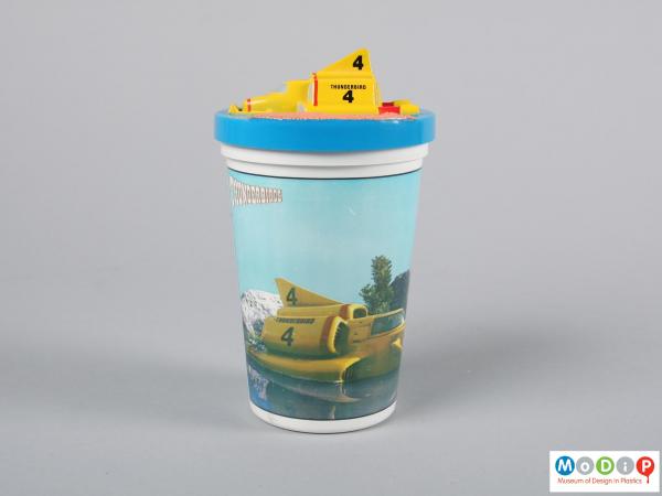 Side view of a beaker showing the moulded vehicle on the lid.